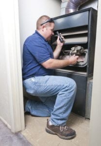 technician-inspects-furnace-safely