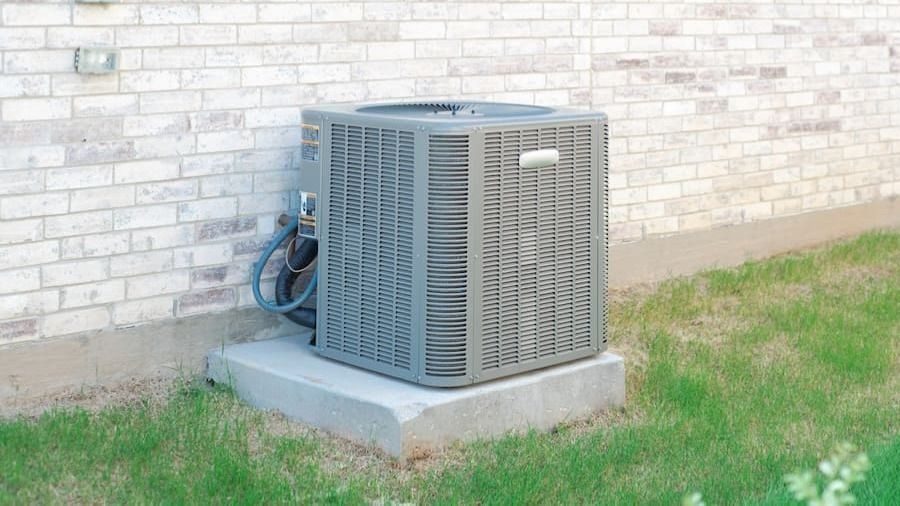 whatsizeairconditionerneedaguide9342 | Climate Control Heating Cooling Plumbing | Climate Control Heating Cooling Plumbing Outdoor air conditioning condenser on a concrete pad beside a light brick wall